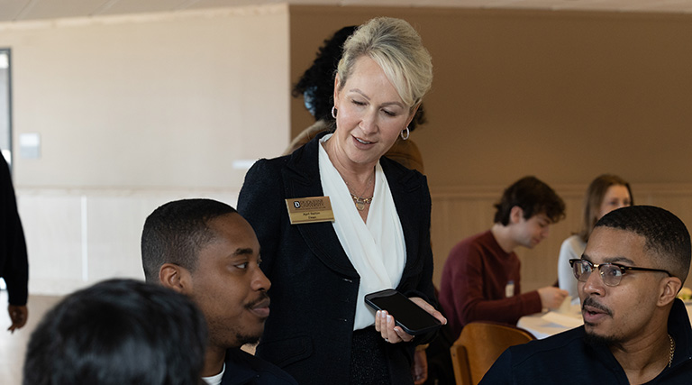 Dean Barton and President Gormley with an alumni reunion group