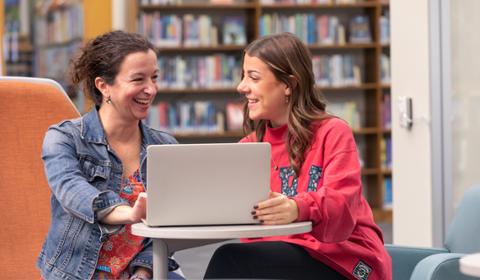 Duquesne student working in library with faculty member