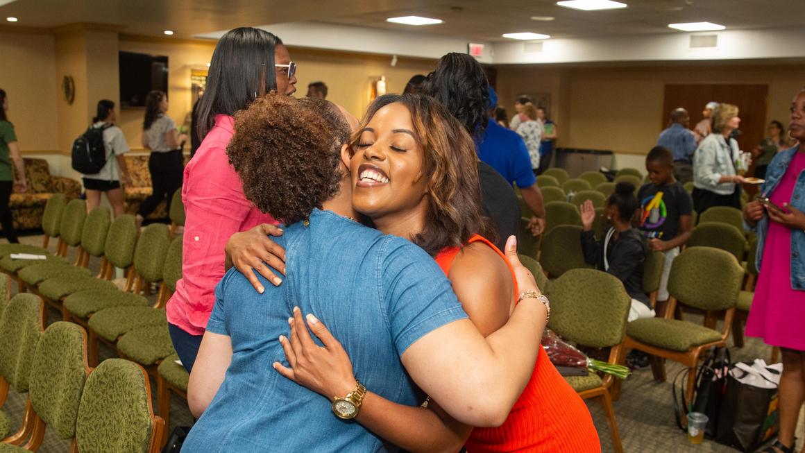 Jacqueline Clarke hugs an audience member at Juneteenth 2024.