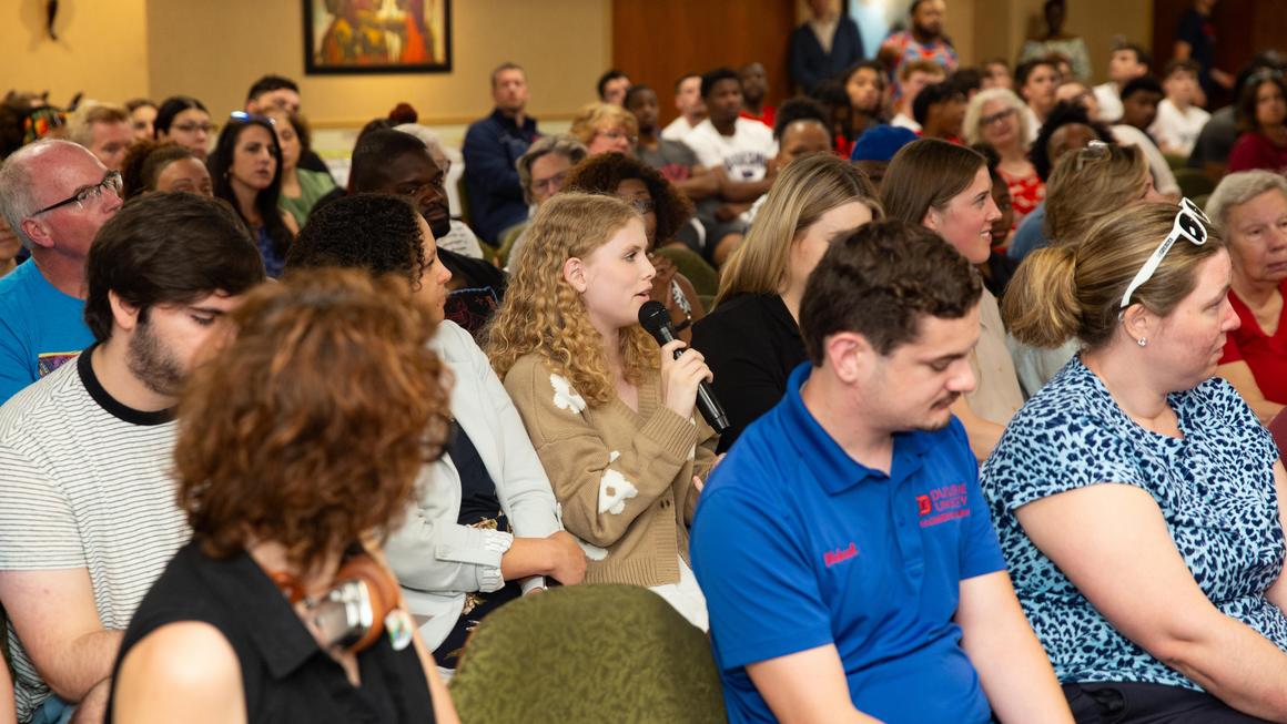 An audience member asks a question to the guest speaker at Juneteenth 2024.