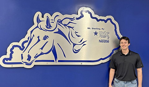 Ronnie Coleman in front of Nestle logo